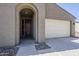Arched entryway and attached garage on a home with low-maintenance landscaping at 7261 E Teal Way, San Tan Valley, AZ 85143