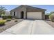 Beautiful house featuring an arched entryway, attached garage, and desert landscaping at 7261 E Teal Way, San Tan Valley, AZ 85143