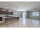 Open-concept kitchen showcasing a spacious island, modern pendant lights, and tile flooring at 7261 E Teal Way, San Tan Valley, AZ 85143