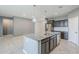 Open kitchen featuring stainless steel appliances, granite countertops, and gray cabinets with a large island sink at 7261 E Teal Way, San Tan Valley, AZ 85143