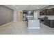 Open kitchen featuring stainless steel appliances, granite countertops, and gray cabinetry with a large island at 7261 E Teal Way, San Tan Valley, AZ 85143