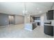 Open kitchen with stainless steel appliances, gray countertops, dark wood cabinets, and an eat-in kitchen island at 7261 E Teal Way, San Tan Valley, AZ 85143