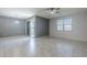 Spacious living room features neutral walls, tile flooring, a modern ceiling fan, and sliding glass doors at 7261 E Teal Way, San Tan Valley, AZ 85143