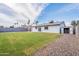 Large backyard with green grass, gravel, and a storage shed at 733 W El Prado Rd, Chandler, AZ 85225