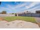 The private backyard has a grassy area, a concrete patio, and block wall fencing at 733 W El Prado Rd, Chandler, AZ 85225