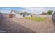 Spacious backyard featuring a grassy lawn and a gravel-covered area at 733 W El Prado Rd, Chandler, AZ 85225
