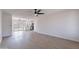 Spacious living room featuring wood floors, modern ceiling fan, and adjacent kitchen at 733 W El Prado Rd, Chandler, AZ 85225
