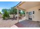 Covered patio with brick pavers overlooking a low-maintenance backyard with gravel and shrubs at 8449 W Rockwood Dr, Peoria, AZ 85382