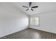 Bedroom featuring gray wood-look flooring, vaulted ceiling, and a ceiling fan at 8449 W Rockwood Dr, Peoria, AZ 85382