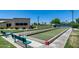 View of the community bocce ball court with benches, green lawns and desert landscaping at 8449 W Rockwood Dr, Peoria, AZ 85382