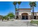 Community clubhouse entrance with stone accents and towering palm trees at 8449 W Rockwood Dr, Peoria, AZ 85382