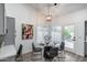 Cozy breakfast nook with modern chandelier, table set for four, art and backyard access at 8449 W Rockwood Dr, Peoria, AZ 85382