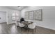 Charming dining room with a wood table, white chairs, decorative art and a window at 8449 W Rockwood Dr, Peoria, AZ 85382