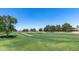View of a well-maintained golf course with lush green grass and desert landscaping at 8449 W Rockwood Dr, Peoria, AZ 85382