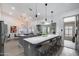 Bright open-concept kitchen with quartz countertops, central island, pendant lights, and stainless steel appliances at 8449 W Rockwood Dr, Peoria, AZ 85382
