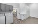 Convenient laundry room with storage cabinets and washer and dryer, accessible from the kitchen at 8449 W Rockwood Dr, Peoria, AZ 85382