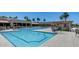 Community swimming pool with pristine clear water, lounge seating and desert landscaping at 8449 W Rockwood Dr, Peoria, AZ 85382