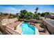 Beautiful backyard oasis featuring a sparkling pool, palm trees, lounge seating, and desert landscaping at 853 W Hemlock Way, Chandler, AZ 85248