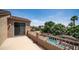 Upstairs balcony overlooking a sparkling swimming pool, lush landscaping, and neighborhood views at 853 W Hemlock Way, Chandler, AZ 85248