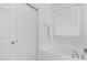 Bright bathroom with a soaking tub, white cabinetry, and a window for natural light at 853 W Hemlock Way, Chandler, AZ 85248