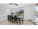 Bright dining area featuring a dark wood table with seating for eight and a view of the backyard pool at 853 W Hemlock Way, Chandler, AZ 85248