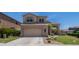 Two-story home with a two-car garage, manicured lawn, and desert landscaping at 853 W Hemlock Way, Chandler, AZ 85248