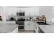 Well-lit kitchen featuring stainless steel appliances, white cabinets, and granite countertops at 853 W Hemlock Way, Chandler, AZ 85248