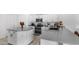 Modern kitchen featuring white cabinets, stainless steel appliances, granite countertops, and a large island at 853 W Hemlock Way, Chandler, AZ 85248