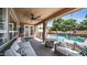 Covered patio with wicker seating, ceiling fan, and view of the sparkling pool and backyard at 853 W Hemlock Way, Chandler, AZ 85248