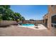 Backyard pool featuring a spa and pergola with a gravel bed, surrounded by block fencing at 853 W Hemlock Way, Chandler, AZ 85248