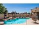 Inviting backyard pool with a pergola, lounge chairs, and a cozy hanging chair at 853 W Hemlock Way, Chandler, AZ 85248
