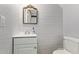 Cozy bathroom featuring a decorative mirror, white vanity, and painted brick accents at 8538 E Portland St, Scottsdale, AZ 85257