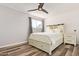 Bedroom featuring modern ceiling fan, a bed with built-in storage drawers and a barn-door-style headboard at 8538 E Portland St, Scottsdale, AZ 85257