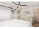 Bedroom featuring a ceiling fan and a closet with sliding barn doors at 8538 E Portland St, Scottsdale, AZ 85257