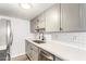 Bright kitchen features stainless steel appliances, grey cabinets, and subway tile backsplash at 8538 E Portland St, Scottsdale, AZ 85257