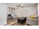 Comfortable living room with ceiling fan, unique staircase with decorative tile, and stylish wood flooring at 8538 E Portland St, Scottsdale, AZ 85257