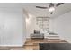 Bright living room with fan, floating shelf staircase, entertainment center, and light-colored walls at 8538 E Portland St, Scottsdale, AZ 85257