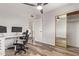 Bright office space featuring hardwood floors, a ceiling fan and a closet with mirrored sliding doors at 8538 E Portland St, Scottsdale, AZ 85257