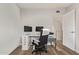 Dedicated office space with dual monitors, hardwood floors, and ample natural light at 8538 E Portland St, Scottsdale, AZ 85257