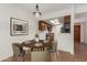 Dining area with a round table, olive green chairs, and a view into the kitchen featuring stainless steel appliances at 8552 E Indian School Rd # B, Scottsdale, AZ 85251