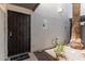 Covered entryway featuring a secure black metal door, desert landscape, and a 'Welcome' mat at 8552 E Indian School Rd # B, Scottsdale, AZ 85251