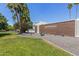 Community front entrance with lush landscaping, featuring desert plants, palm trees, and a sign reading Casita Real at 8552 E Indian School Rd # B, Scottsdale, AZ 85251
