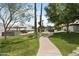 Lush community green space with manicured walkway and palm trees at 8552 E Indian School Rd # B, Scottsdale, AZ 85251