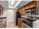 Kitchen with wood cabinetry, stainless steel appliances, and a skylight for natural light at 8552 E Indian School Rd # B, Scottsdale, AZ 85251