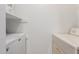 Laundry room features stacked washer dryer and shelf storage at 8552 E Indian School Rd # B, Scottsdale, AZ 85251