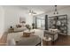 Bright living room with modern furnishings, neutral tones, ceiling fan, and sliding doors to the outdoor patio at 8552 E Indian School Rd # B, Scottsdale, AZ 85251