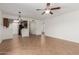 Open living space featuring tile floors, a ceiling fan, and a view into the kitchen with stainless steel appliances at 8552 E Indian School Rd # B, Scottsdale, AZ 85251