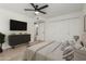 Bright main bedroom with plush carpet, ceiling fan, closet, and a mounted TV on the wall at 8552 E Indian School Rd # B, Scottsdale, AZ 85251