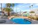 Refreshing community pool with palm trees, lounge chairs, and mural at 8552 E Indian School Rd # B, Scottsdale, AZ 85251