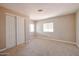 A bright bedroom with neutral carpet features a closet and well-lit windows at 8600 E Broadway Rd # 53, Mesa, AZ 85208